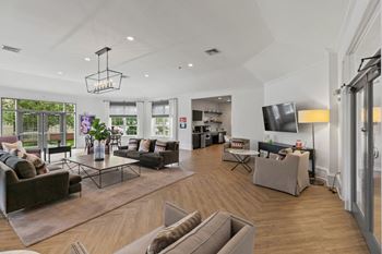 a living room with couches and chairs and a tv at The Austin Apartment Homes, New Jersey, 08096